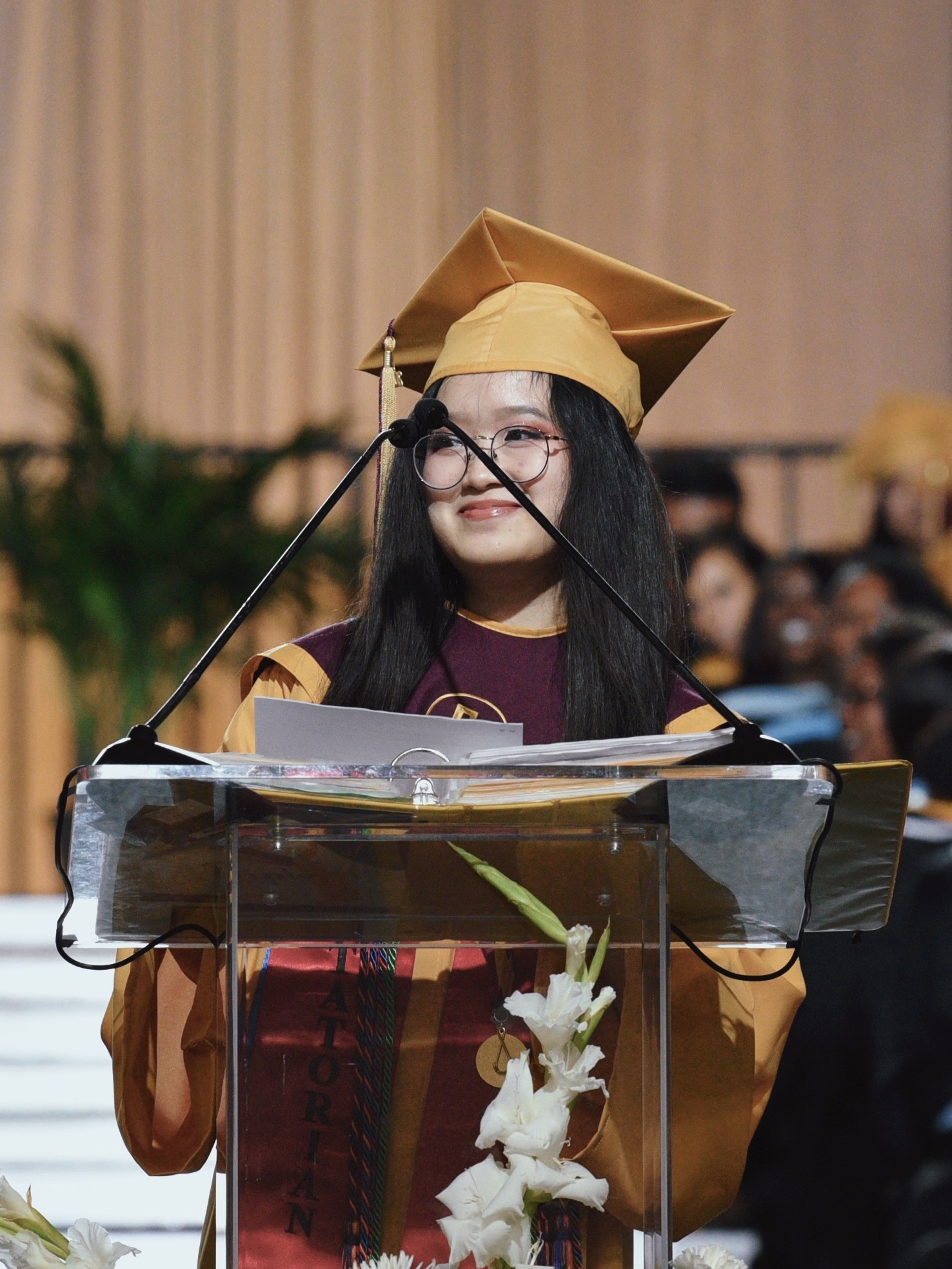 Me in front of the podium at my 2022 high school graduation
